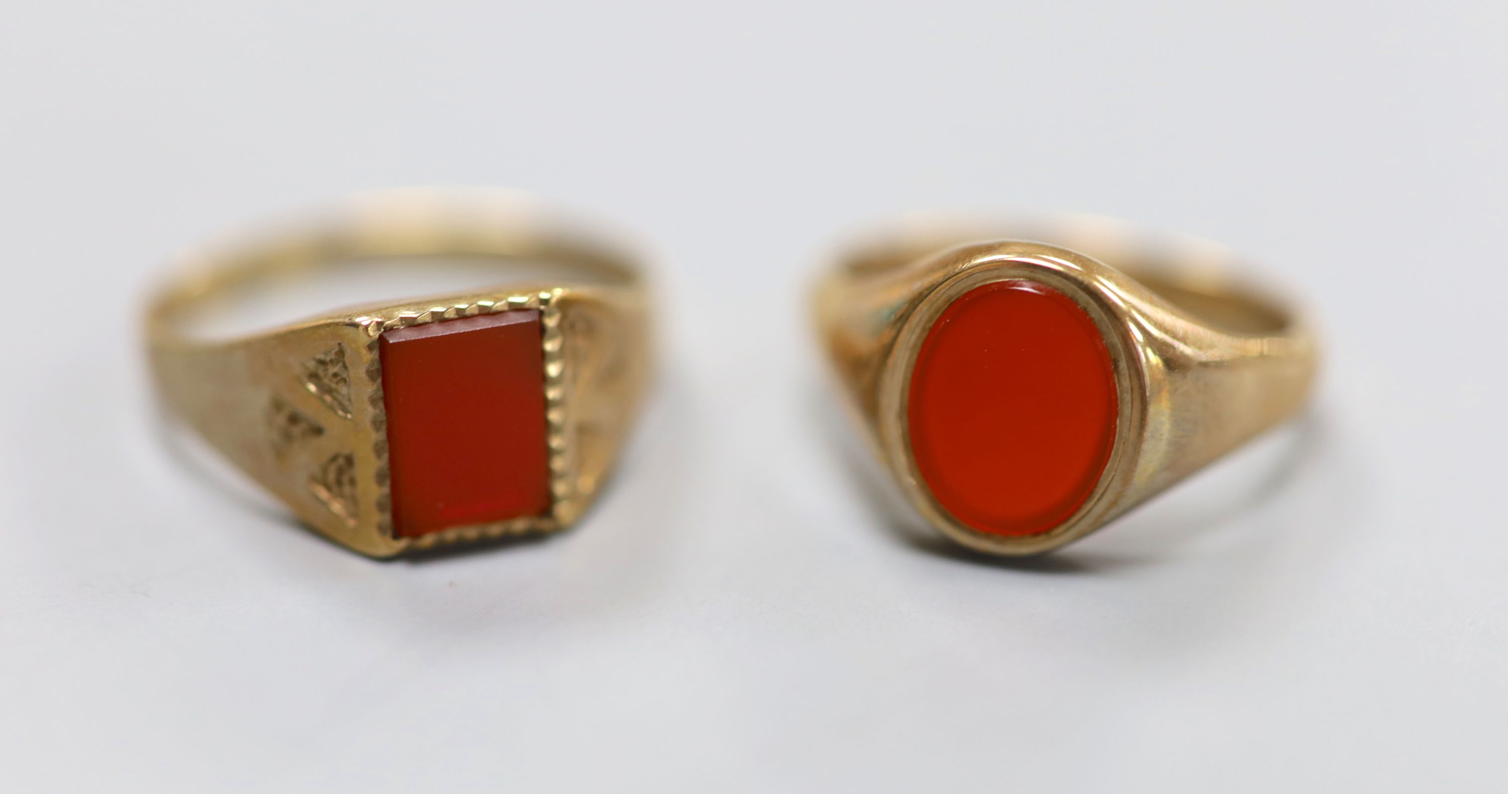 Two modern 9ct gold and carnelian set signet rings, sizes U & Q, gross 6.6 grams.